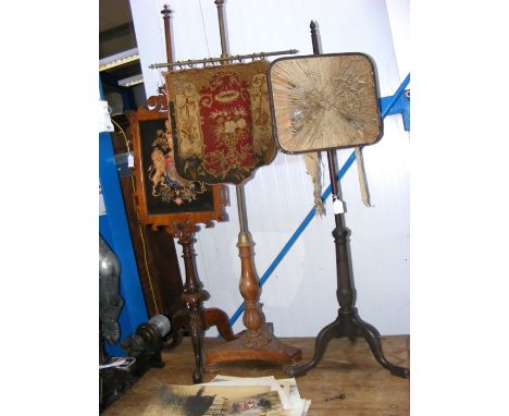 A 19th century pole screen with embroidery panel, together with two others 