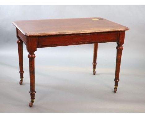   A Victorian mahogany writing table,with rounded rectangular top inset with a brass capped inkwell, on turned tapered legs,W