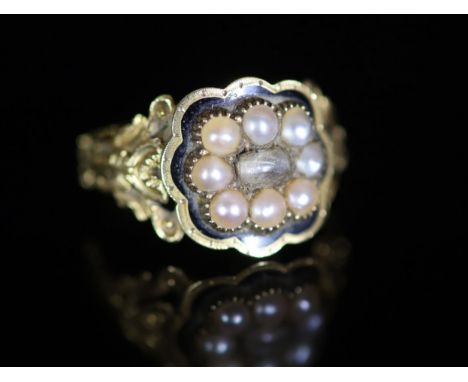   A William IV 18ct gold, black enamel and seed pearl set mourning ring,with central rock crystal? panel, carved foliate shou