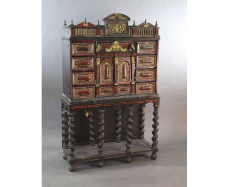   A late 17th century Portuguese ormolu mounted ebony and red tortoiseshell cabinet on stand,of architectural form, with two 