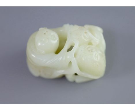   A Chinese pale celadon jade group of a boy and a lion-dog, 19th/20th century,the lion-dog grasping ribbons of a brocaded ba