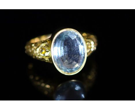   A Victorian style gold and single stone oval cut aquamarine dress ring,with carved shoulders, size M, gross 5.4 grams, make