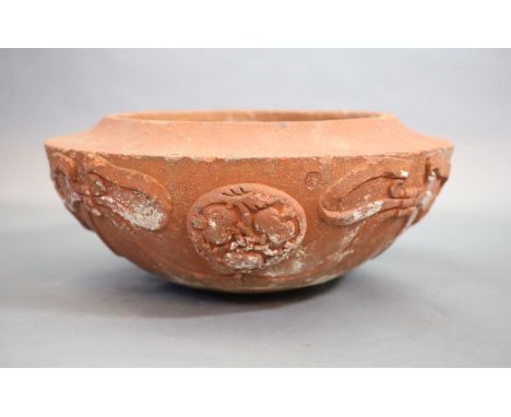   A Compton pottery ‘seasons’ terracotta planter, early 20th century,of circular form, the sides modelled with foliate cartou