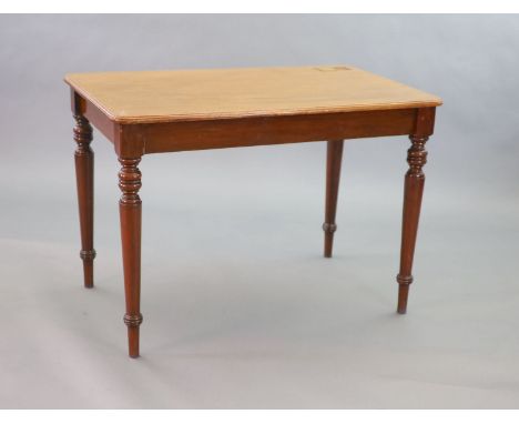   A Victorian mahogany writing table,with rounded rectangular top inset with a brass lidded inkwell, on turned tapered legs,W