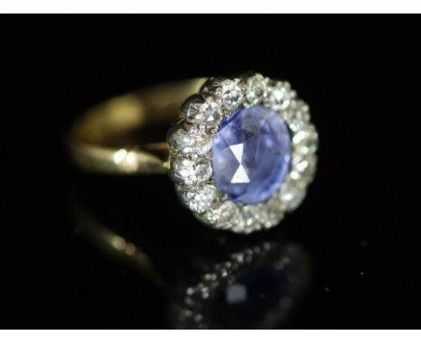   A 19th century? gold, sapphire and diamond set circular cluster ring,the central Ceylon? sapphire bordered with old cut dia