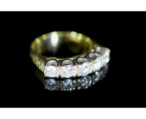   A modern 18ct gold and graduated five stone diamond set half hoop ring,with a total carat weight of 1.06ct and textured sho