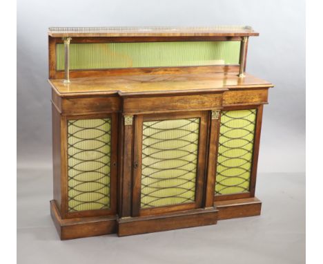   A Regency rosewood breakfront chiffonier, the raised back with three quarter gallery,glazed silk lined backing panel over t