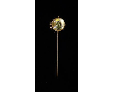   A late 19th century French 18ct gold and Essex crystal stick pin decorated with jockeys colours,72mm gross 5 grams.see lot 