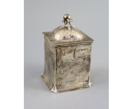 An Edwardian Art Nouveau silver tea caddy by Connell,of square form, with planished cover and ball finial, Birmingham, 1906, 