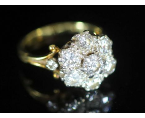   A mid 20th century gold and seven stone diamond cluster ring,with diamond set shoulders, total diamond weight approximately