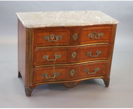   A Louis XVI parquetry serpentine commode,with variegated grey marble top, two short and two long drawers, flanked by brass 