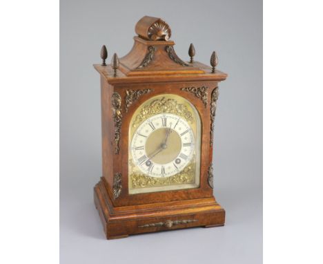   A late 19th century walnut cased bracket clock,with a silvered chapter ring with black Roman and Arabic numerals, cornered 