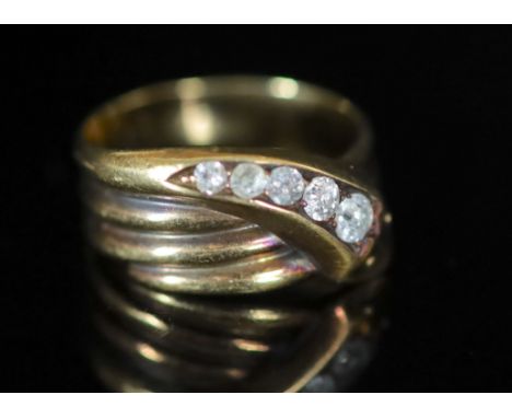   A George V 18ct gold and graduated five stone diamond set coiled serpent ring,size Q, gross weight 7 grams.