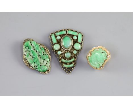   Two Chinese jadeite and gilt metal clips, first half 20th century and a yellow metal jadeite ‘fish’ ring, late 20th century