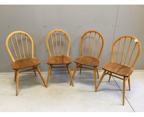 A set of four mid century Ercol style elm and beech comb back dining chairs, height 85cm. Condition - poor to fair