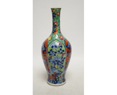 A Chinese clobbered blue and white bottle vase, Kangxi, 26cm high. Condition - ground off rim and hairline crack to neck Neck