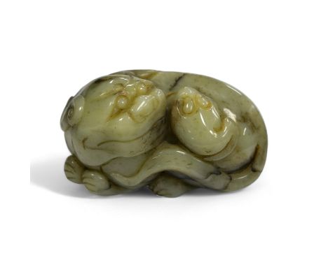 A Chinese jade figure of a lion-dog, 7.5cm wide, 4.3cm high. Condition - good