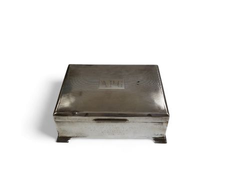 A George VI part engine turned silver cigarette box, Birmingham, 1948, with engraved inscription, on bracket feet, 17.3cm. Co