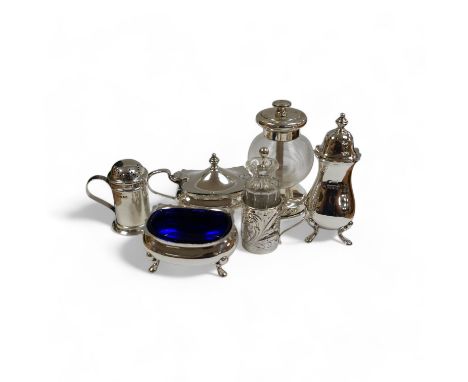 Six assorted silver condiments including a mounted ribbed glass pepper grinder and an Edwardian mounted glass cayenne pepper 