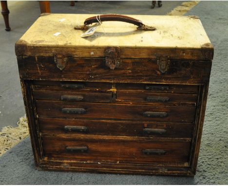 Small pine artisans cabinet with lift lid above an arrangement of seven drawers, originally having a closing panel to the fro