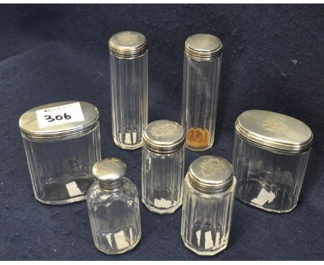 A group of assorted plain silver topped glass dressing table jars with pillar cut bodies. (7) (B.P. 21% + VAT)&nbsp;General w