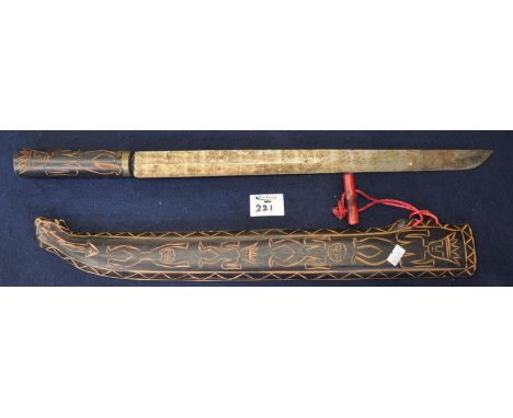 South American or Asian souvenir Parang type jungle knife with wooden scabbard and handle decorated with incised figures. (B.