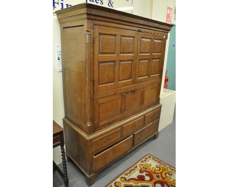 Early 19th Century oak low press cupboard having fluted cornice over two panelled doors revealing single shelf to the interio