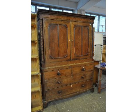 Early 19th Century oak two stage press cupboard having moulded cornice, the interior with two fitted shelves, blind panelled 