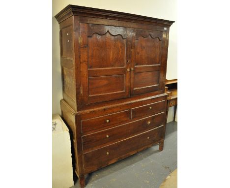 Early 19th Century Welsh oak two stage press cupboard, having moulded cornice over a pair of pointed arch panelled doors reve