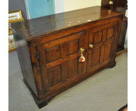 Early 19th Century Welsh oak low two door panelled cupboard on bracket feet. (B.P. 21% + VAT) Good colour, wear and tear with