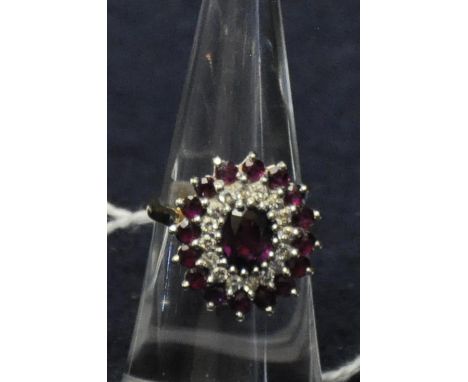 18ct gold ruby and diamond cluster ring. Size K. Approx weight 5.7g.(B.P. 21% + VAT) 