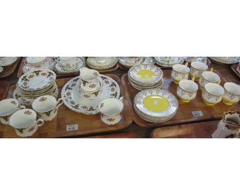 An 18 piece Kevin pottery bone china teaset on a yellow and white gilded ground, together with a tray of Balmoral Royal Staff