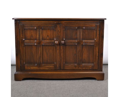 Ercol music cabinet, dark elm, hinged lid above a cupboard, width 105cm, depth 51cm, height 70cm.