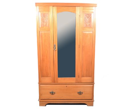 Edwardian satin walnut wardrobe, moulded cornice, mirror door enclosing hooks and a short hanging rail, drawer base, bracket 