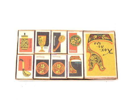 A boxed set of vintage Russian matchboxes; a vintage carpet beater, 82.5cm; and modern red leather oval boxes, 30cm and 25cm.