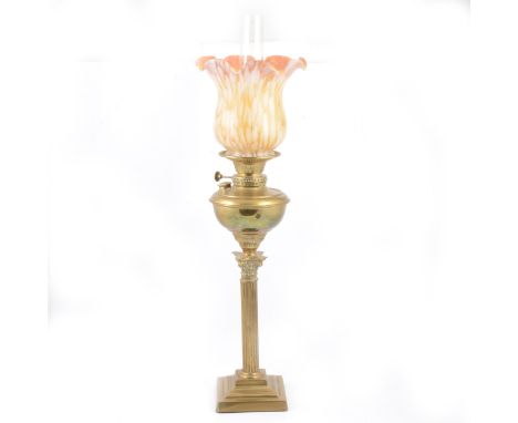 A brass Corinthian column oil lamp, converted to electricity, peach and white coloured glass shade, 71cm.