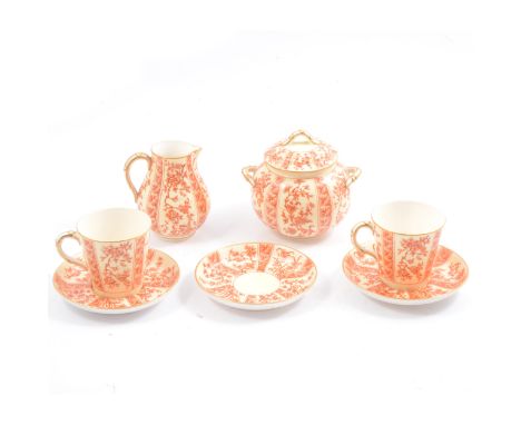 A Royal Worcester tea-for-two set, cream ground, red floral pattern, gilt rim, comprising cups, saucers, lidded sugar bowl an