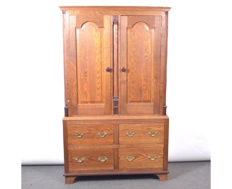 Modern oak craftsman made press cupboard, moulded cornice, the upper section with two panelled doors enclosing two shelves, f