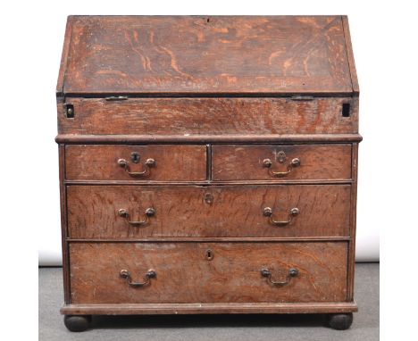 George III oak bureau, fall front enclosing an interior with drawers, pigeon holes and a well, two short and two long graduat