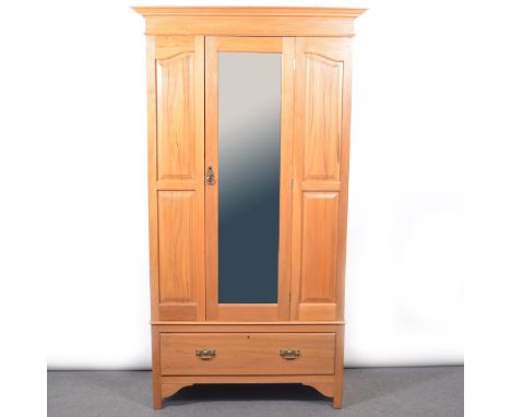 Edwardian satin walnut wardrobe, moulded cornice, plain frireze, mirror door enclosing a hanging rail, drawer base, bracket f