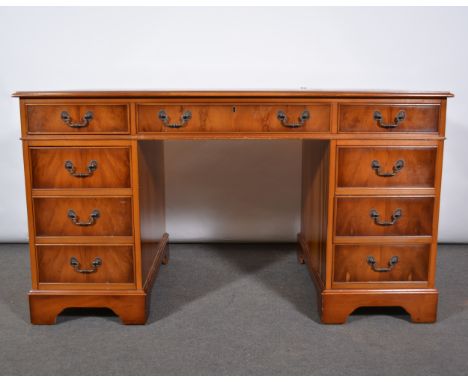 Modern yew twin pedestal desk, rectangular top with leather inset, nine drawers, bracket feet, width 137cm, depth 76cm, heigh