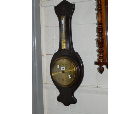 A CARVED OAK ANEROID BAROMETER, with brass face