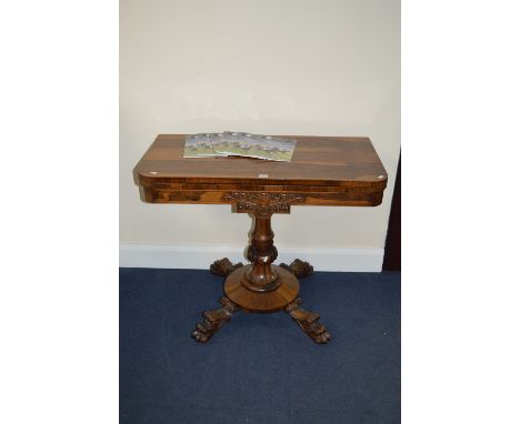 A VICTORIAN ROSEWOOD RECTANGULAR FOLD OVER CARD TABLE, circular baize inset on a fluted and carved pedestal to a circular bas