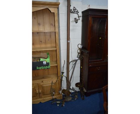 A COPPER AND BRASS LIGHTING RAIL, with four electric light fitting, acanthus leaf foliage ends, (no shades), approximate leng
