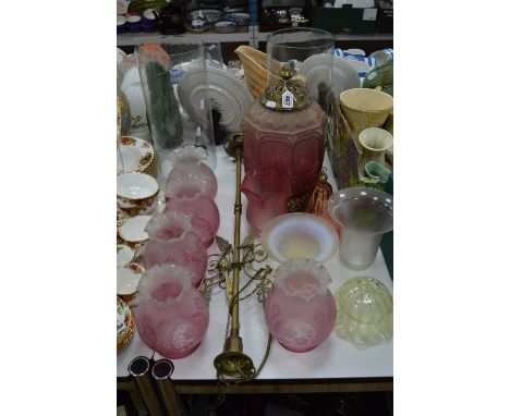 A SET OF FIVE ART NOUVEAU STYLE CRANBERRY GLASS LIGHT SHADES, together with similar hanging light with brass fittings and oth