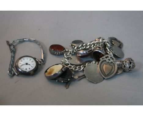 A SILVER CHARM BRACELET, with various charms, fobs, etc, together with a S W R ladies watch