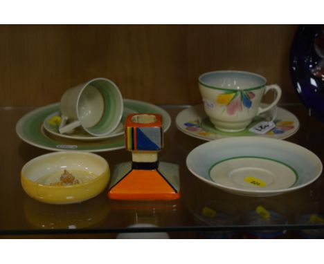 CLARICE CLIFF FOR NEWPORT POTTERY AND WILKINSON LTD, to include 'Crocus' cup (hairline), side plate, a trio green and brown b