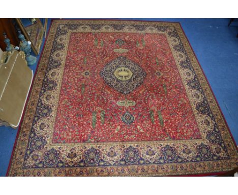 A 100% WOOL CARPET SQUARE, red, gold and blue ground, Woodward Grosvenor Persian Reproductions label attached