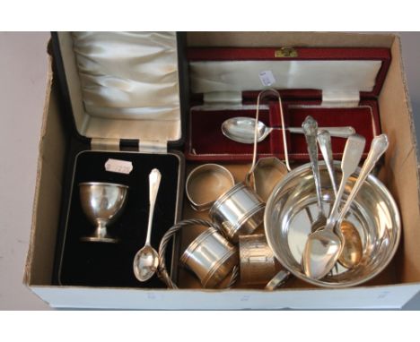 FIVE VARIOUS SILVER NAPKIN RINGS, a pair of silver sugar tongs, a silver bangle, a circular silver bowl with twin handles and