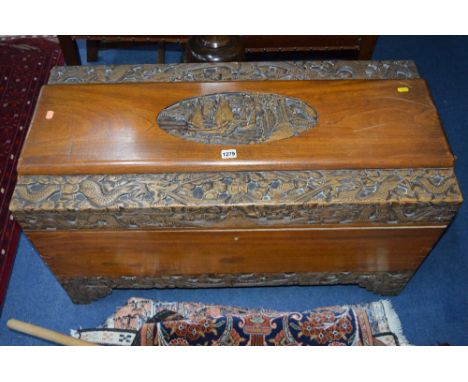 A CARVED CAMPHOR BLANKET CHEST, width 94cm x depth 45cm x height 52cm and a barometer (2)
